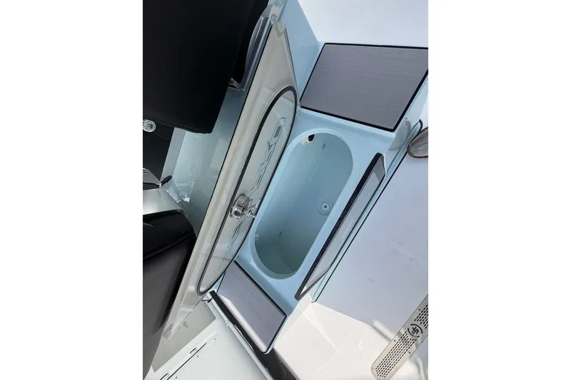 Slide: The Image of 2026 Sea Pro 245FLXR Sandbar boat interior with storage compartment and seating. - 38