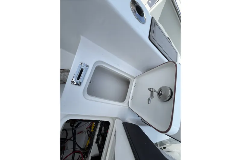 Slide: The Image of Interior view of 2026 Sea Pro 245FLXR Sandbar boat, showcasing storage compartments and fixtures. - 43
