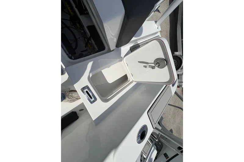 Slide: The Image of Open storage compartment on 2026 Sea Pro 245FLXR Sandbar boat deck. - 23