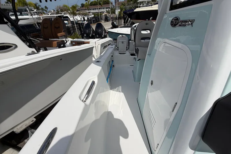 Slide: The Image of 2026 Sea Pro 245FLXR Sandbar boat interior with seating and storage compartments. - 28