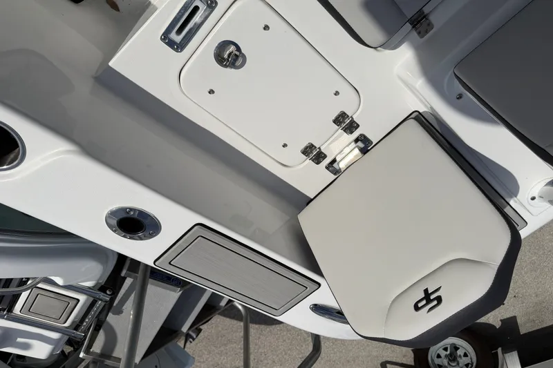 Slide: The Image of 2026 Sea Pro 245FLXR Sandbar boat interior with seating and storage compartments. - 35