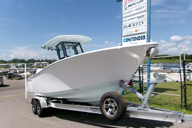 The Image of 2027 Sportsman Open 252 Center Console boat on trailer at dealership. - 1