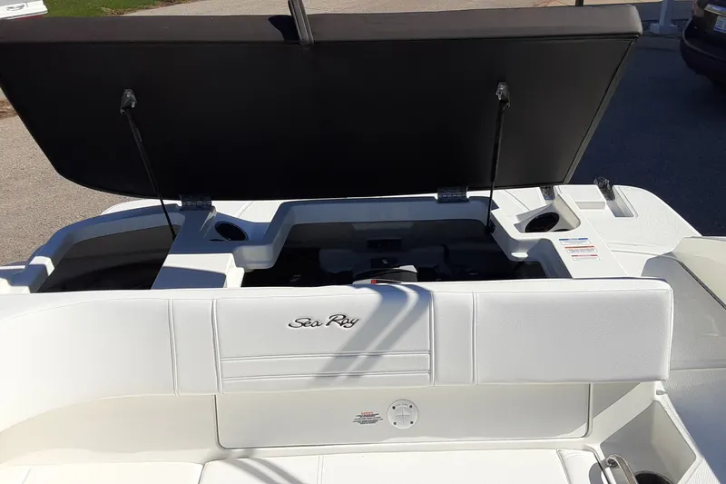 Slide: The Image of 2020 Sea Ray SPX 190 boat with open storage compartment, white seating, and sleek design. - 14