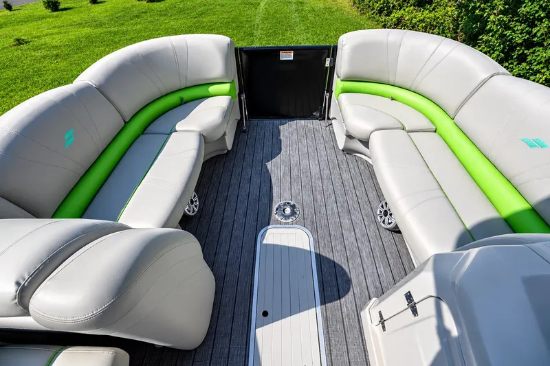 Slide: The Image of 2018 Starcraft SLS 5 Q boat interior with gray and green seating, spacious layout. - 6