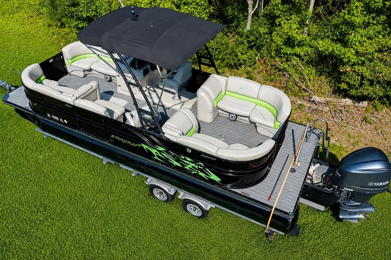 Slide: The Image of 2018 Starcraft SLS 5 Q pontoon boat with Yamaha motor on grassy area. - 8