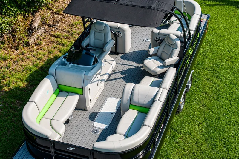 Slide: The Image of 2018 Starcraft SLS 5 Q pontoon boat with luxurious seating and canopy on grassy background. - 10