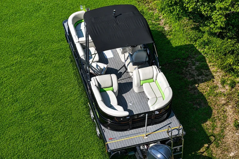 Slide: The Image of 2018 Starcraft SLS 5 Q pontoon boat with canopy on grassy area. - 9
