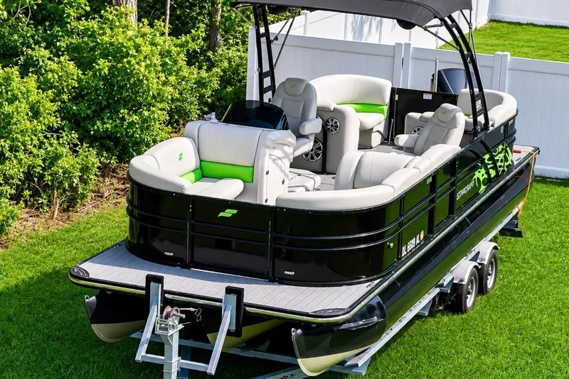 Slide: The Image of 2018 Starcraft SLS 5 Q pontoon boat with sleek design and comfortable seating on a trailer. - 11