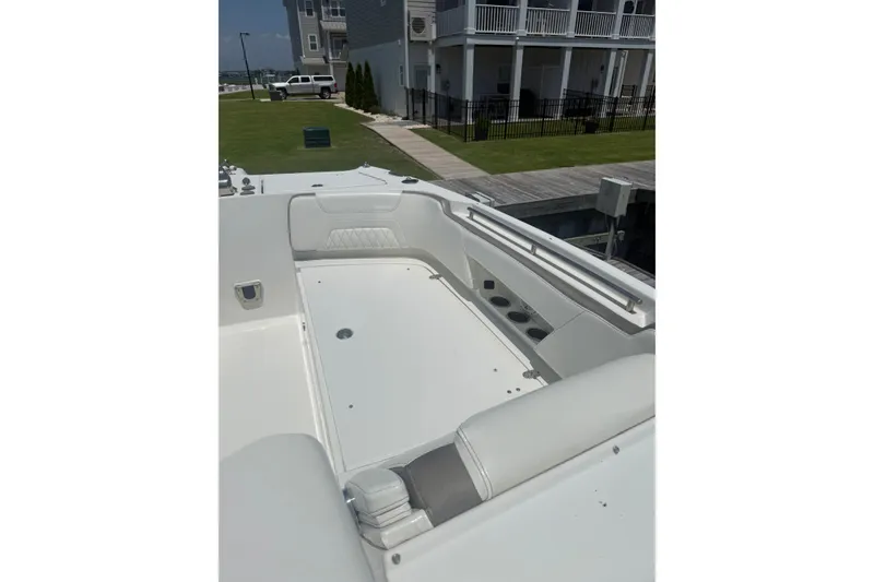 Slide: The Image of 2022 World Cat 325 DC boat interior with white seating and cup holders. - 4