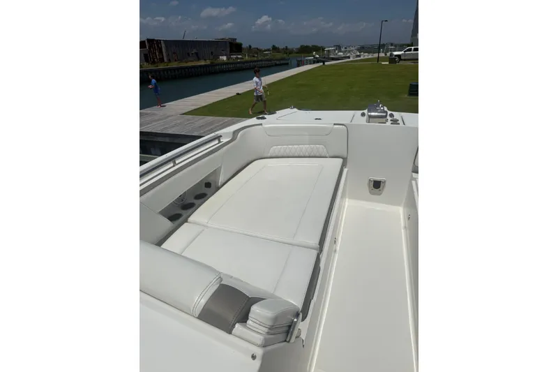 Slide: The Image of 2022 World Cat 325 DC boat with spacious white seating area. - 5