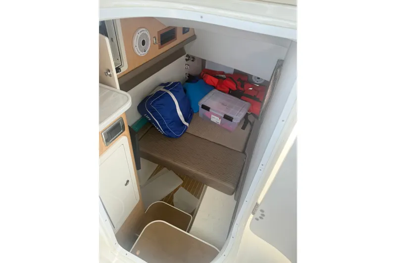 Slide: The Image of Interior cabin of 2022 World Cat 325 DC boat with storage and seating. - 6