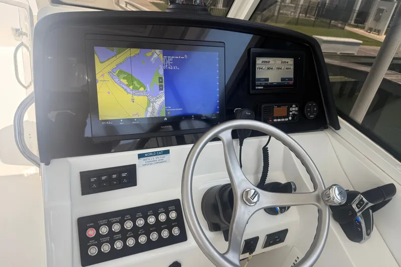 Slide: The Image of 2022 World Cat 325 DC helm with navigation screens and controls. - 2