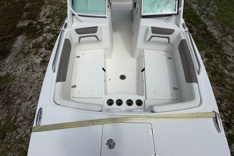 Slide: The Image of 2022 World Cat 230 DC boat interior, featuring spacious seating and storage compartments. - 64
