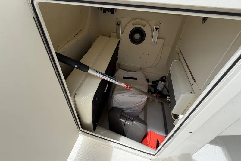 Slide: The Image of Storage compartment of 2022 World Cat 230 DC boat with various equipment inside. - 57