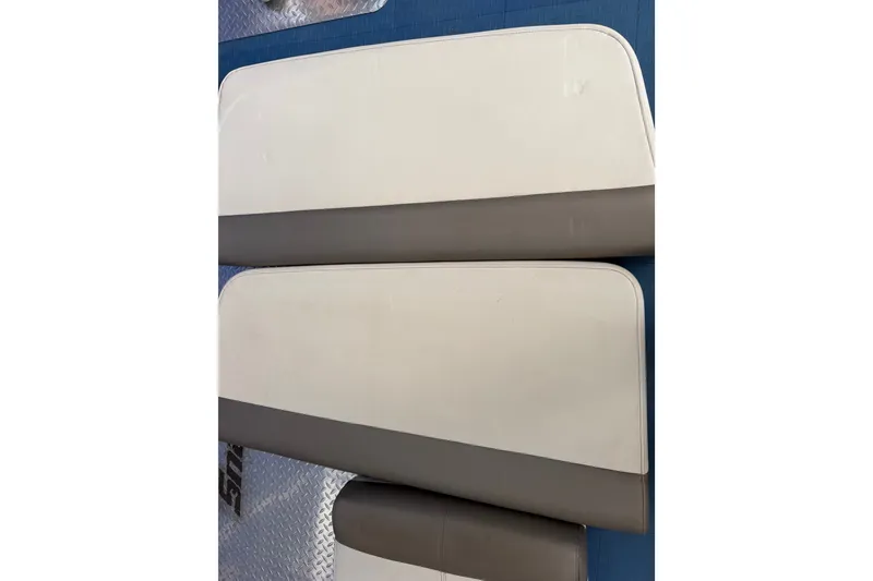 Slide: The Image of 2022 World Cat 230 DC boat seat cushions, featuring white and gray upholstery. - 74