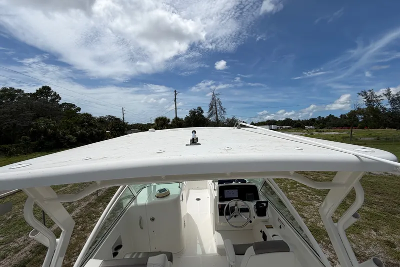 Slide: The Image of 2022 World Cat 230 DC boat with spacious cockpit under a clear blue sky. - 53