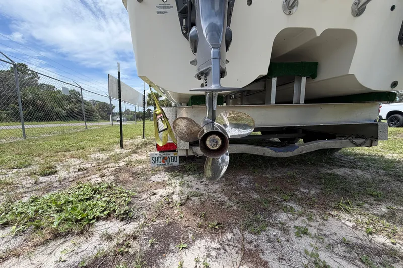 Slide: The Image of Rear view of a 2022 World Cat 230 DC boat on a trailer, showing the propeller. - 20