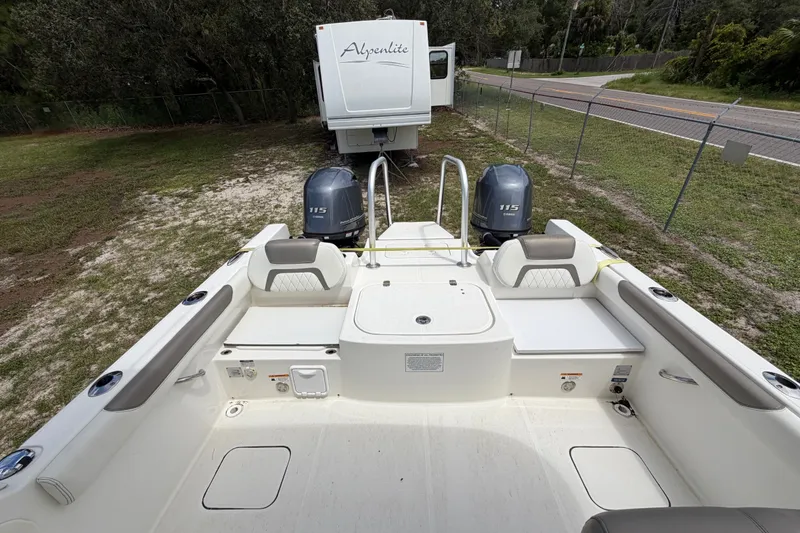 Slide: The Image of 2022 World Cat 230 DC boat with dual 115 engines, parked near an RV. - 47