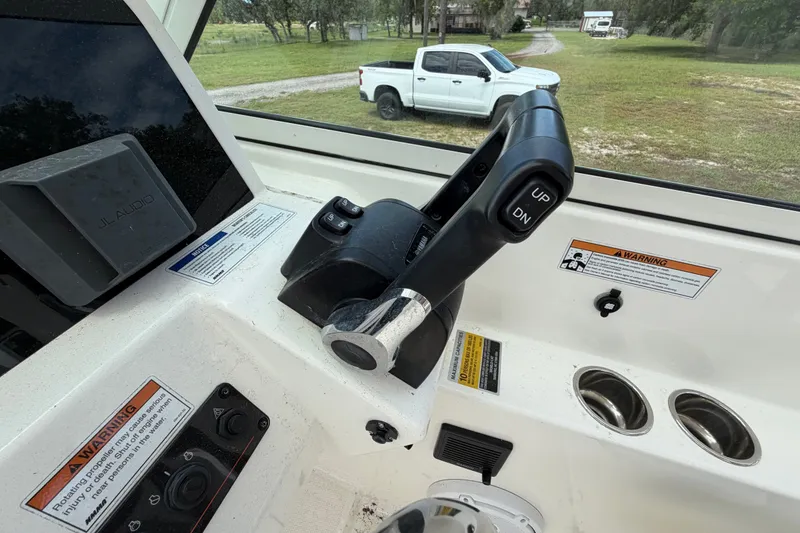 Slide: The Image of 2022 World Cat 230 DC boat controls with JL Audio system and warning labels. - 44