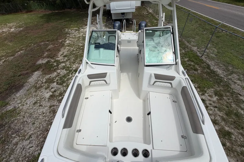 Slide: The Image of 2022 World Cat 230 DC boat interior with open seating and storage compartments. - 60