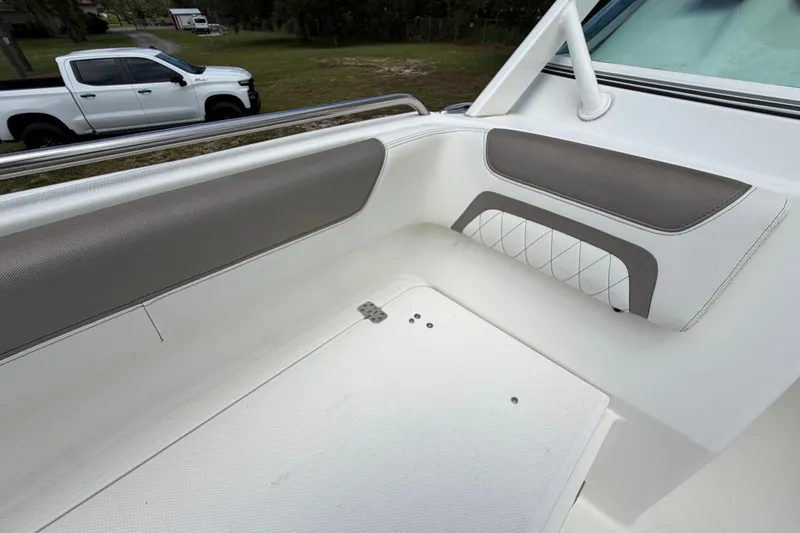 Slide: The Image of 2022 World Cat 230 DC boat interior with cushioned seating and sleek design. - 71