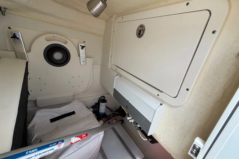 Slide: The Image of Interior view of a 2022 World Cat 230 DC boat, showcasing storage and equipment. - 59