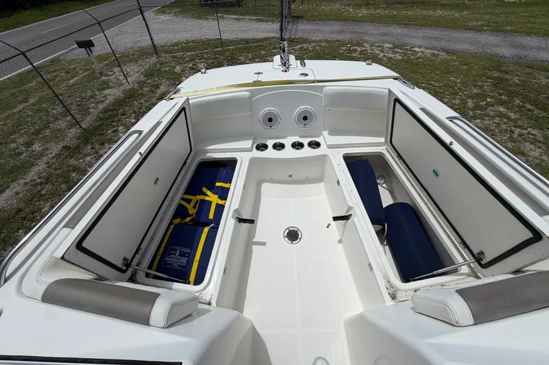 Slide: The Image of 2022 World Cat 230 DC boat interior with open storage compartments and seating. - 65