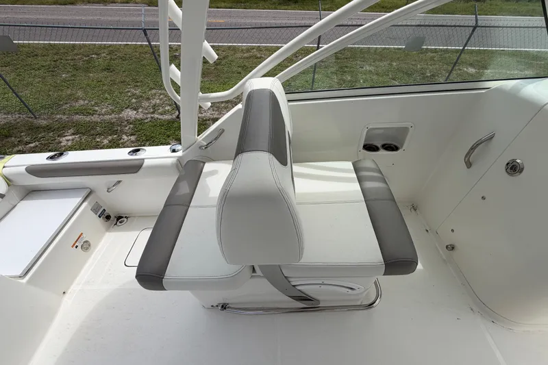Slide: The Image of 2022 World Cat 230 DC boat interior with white and gray seating. - 49