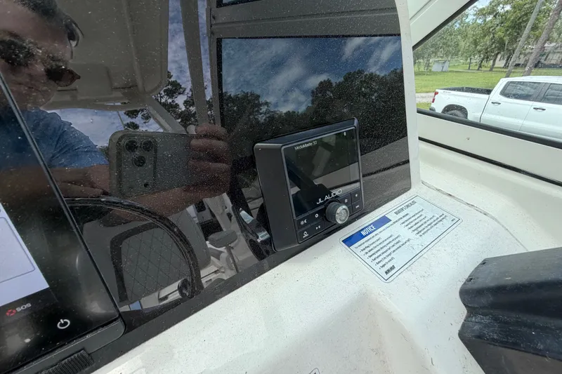 Slide: The Image of 2022 World Cat 230 DC dashboard with JL Audio system and reflection. - 46