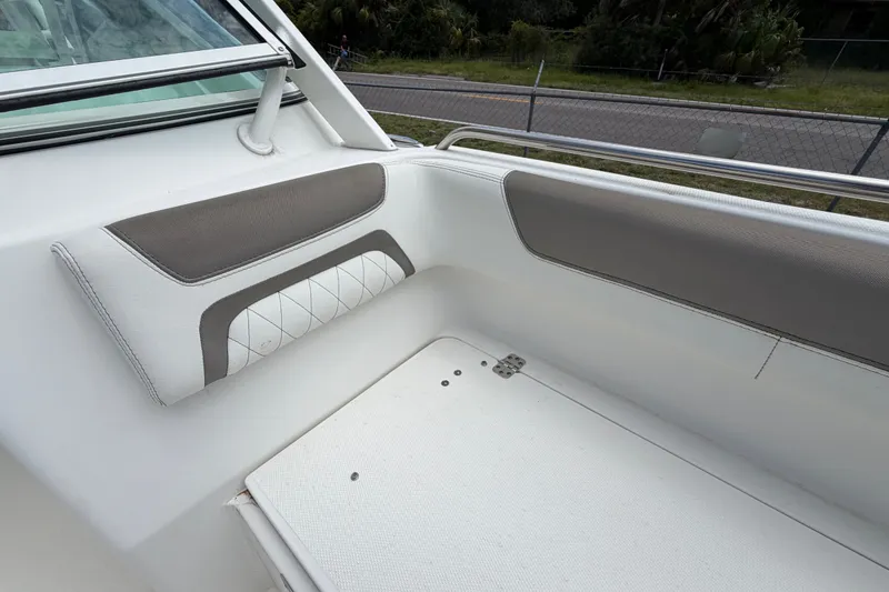 Slide: The Image of Interior seating of a 2022 World Cat 230 DC boat, featuring white and gray upholstery. - 69