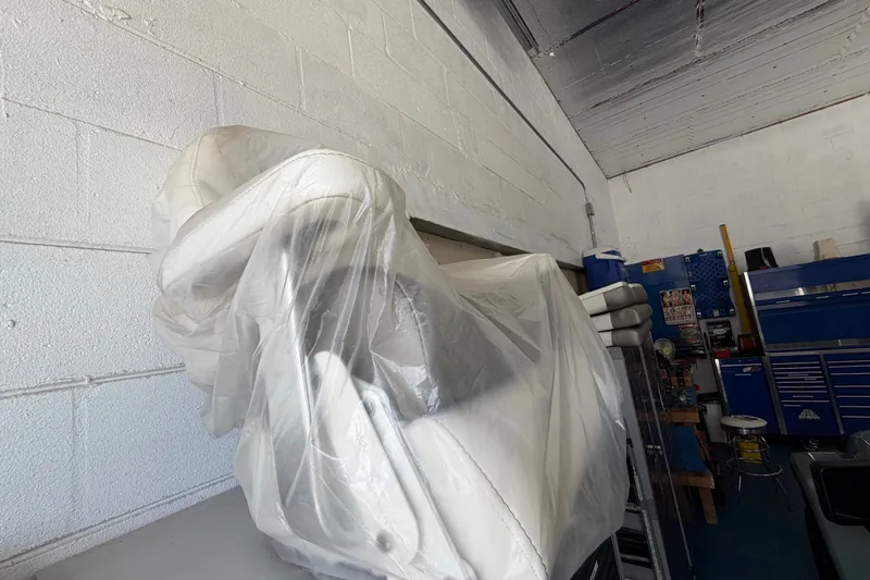 Slide: The Image of Covered 2022 World Cat 230 DC boat seats in a storage garage. - 72