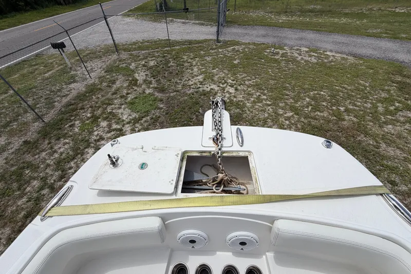 Slide: The Image of 2022 World Cat 230 DC boat deck with anchor chain and storage compartment. - 66
