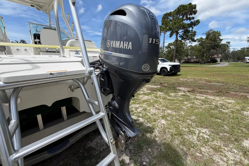 Slide: The Image of 2022 World Cat 230 DC boat with Yamaha 115 outboard motor on grassy area. - 24