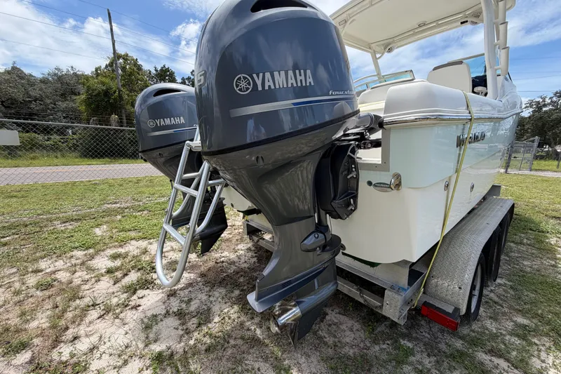 Slide: The Image of 2022 World Cat 230 DC boat with dual Yamaha outboard motors on a trailer. - 25