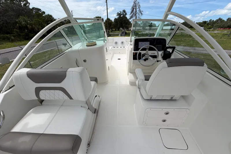 Slide: The Image of 2022 World Cat 230 DC boat interior with modern seating and steering console. - 38