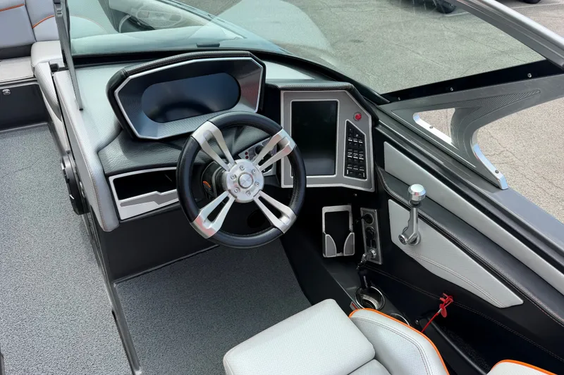 Slide: The Image of 2018 MasterCraft X26 boat cockpit with modern steering wheel and control panel. - 11