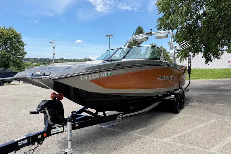 Slide: The Image of 2018 MasterCraft X26 boat on trailer in parking lot, sunny day. - 4