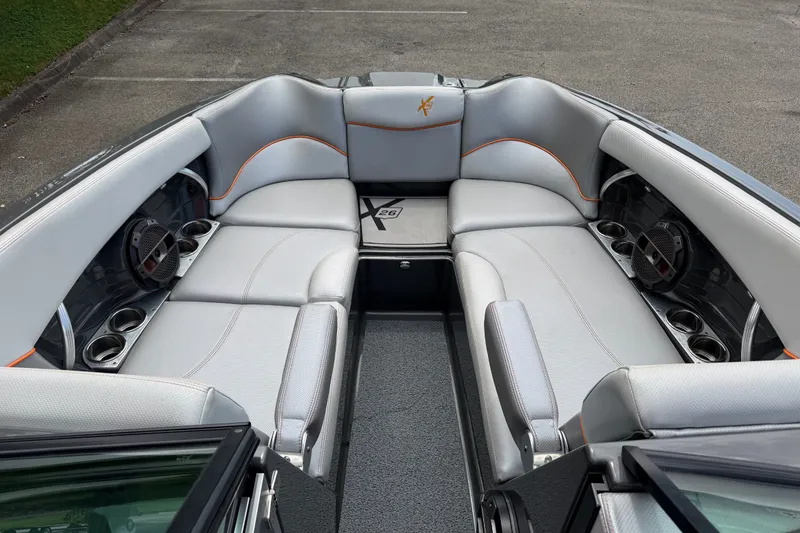 Slide: The Image of 2018 MasterCraft X26 boat interior with luxurious seating and built-in speakers. - 9