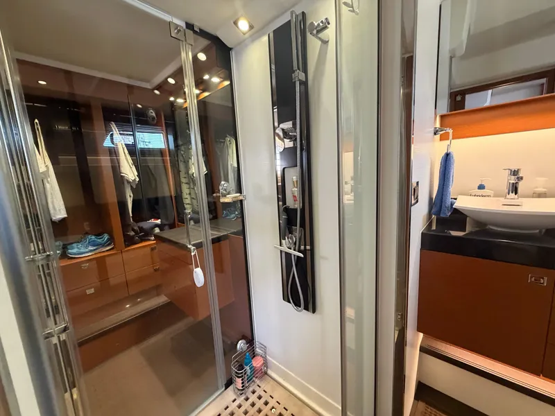 Slide: The Image of The image shows a modern yacht bathroom with a shower and sink. - 44