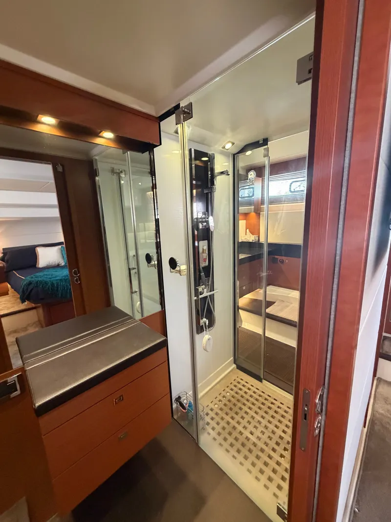 Slide: The Image of Luxurious bathroom with modern shower and wooden cabinetry on a Prestige 550 yacht. - 42