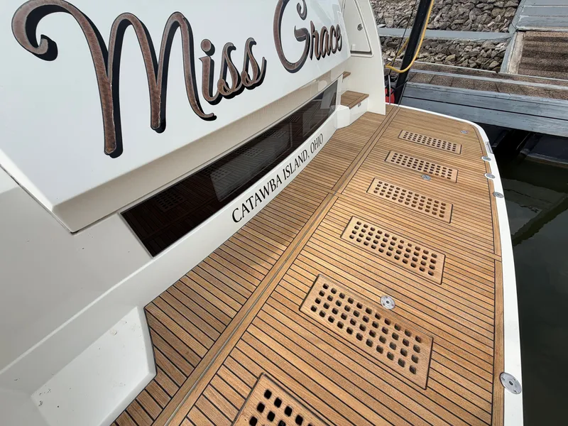 Slide: The Image of The 2015 Prestige 550 features a sleek teak deck with the name "Miss Grace." - 4