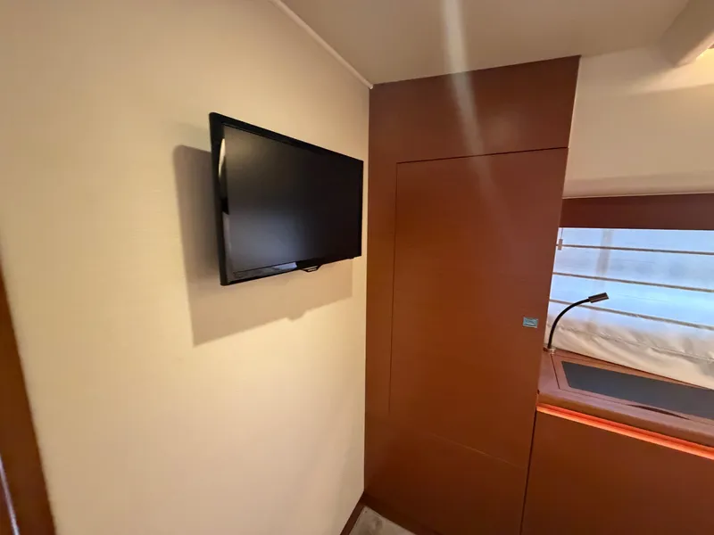 Slide: The Image of Interior of a 2015 Prestige 550 with a flat-screen TV mounted on the wall. - 29