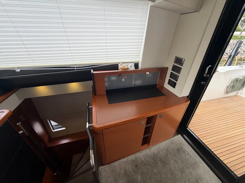 Slide: The Image of Interior of a 2015 Prestige 550 with wooden cabinetry and carpeted flooring. - 15