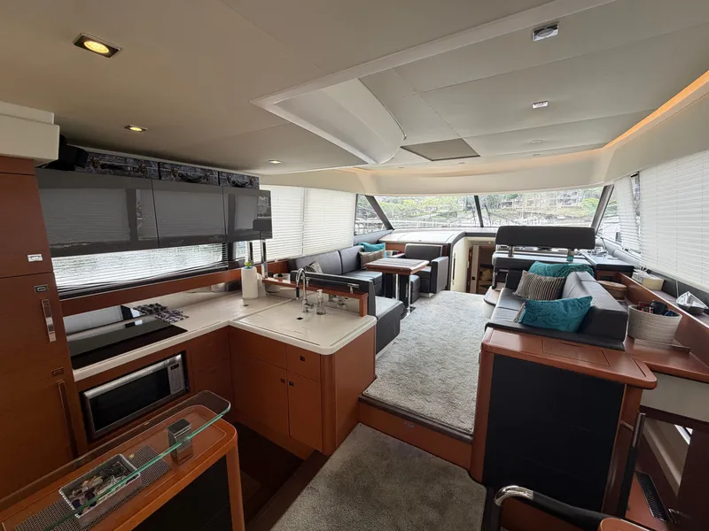 Slide: The Image of Interior of a 2015 Prestige 550 yacht with a modern kitchen and cozy living area. - 14