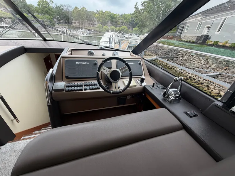 Slide: The Image of The image shows the cockpit of a 2015 Prestige 550 with a sleek helm and modern instruments. - 21