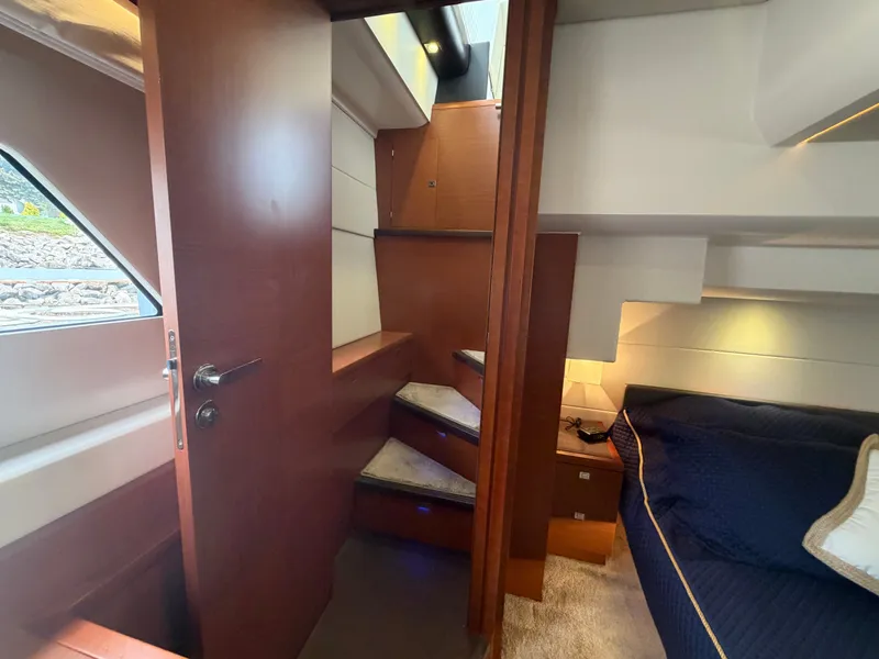 Slide: The Image of Interior of a 2015 Prestige 550 with stairs and sleeping area. - 40