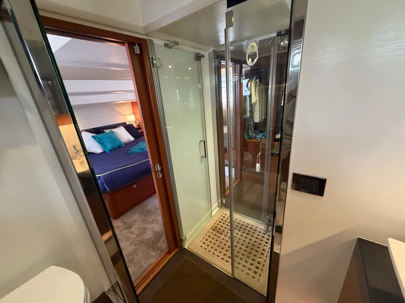Slide: The Image of The 2015 Prestige 550 features a luxurious bedroom and a modern bathroom with a shower. - 45