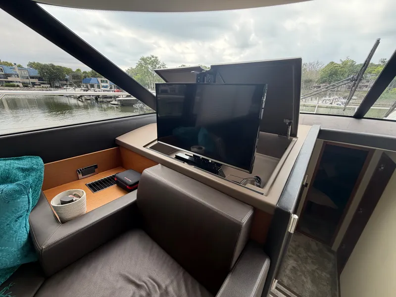 Slide: The Image of The image shows the interior of a 2015 Prestige 550 yacht with a retractable TV. - 22