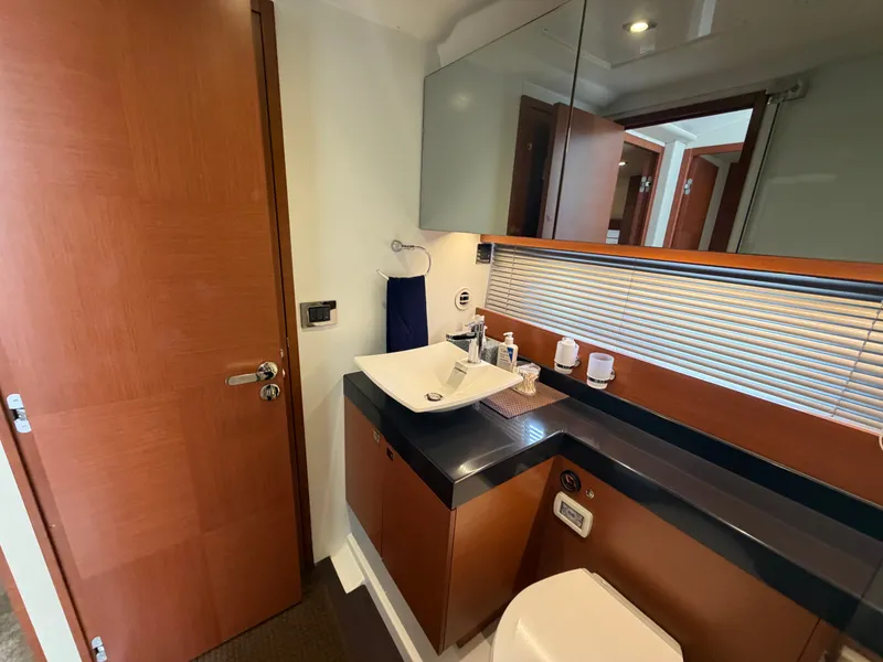 Slide: The Image of The image shows a modern yacht bathroom with wood paneling and a stylish sink. - 32