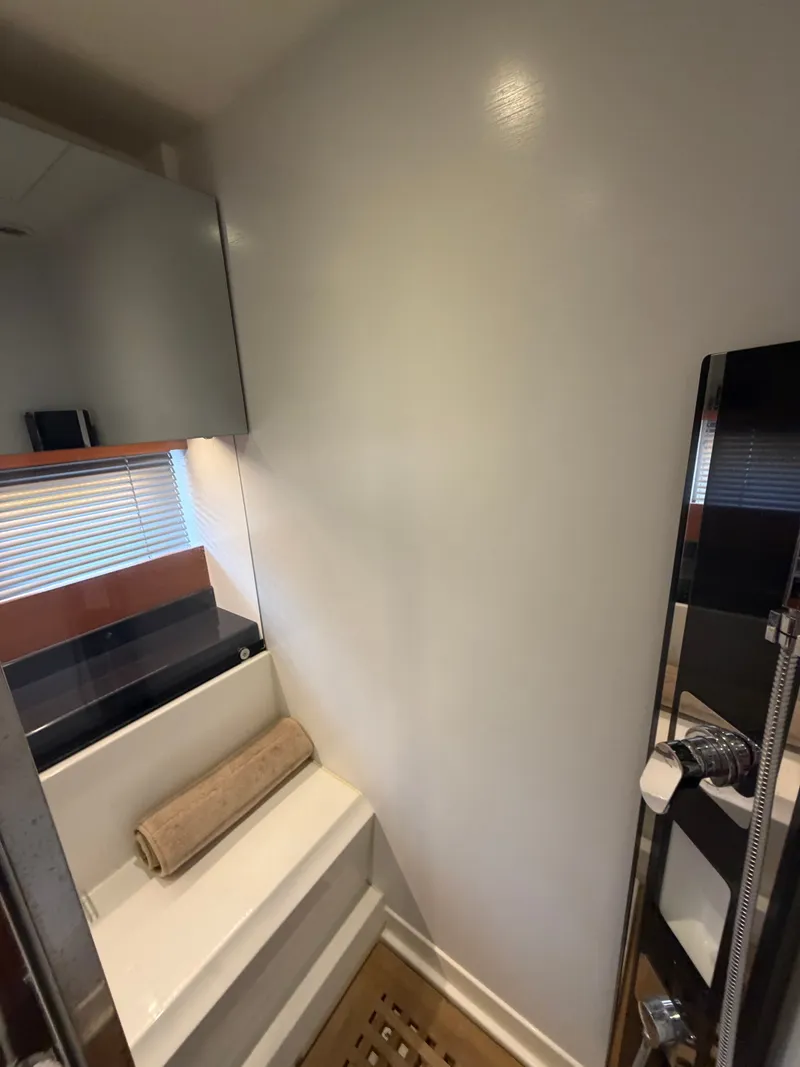 Slide: The Image of The image shows a modern yacht bathroom with a shower and a sink. - 33